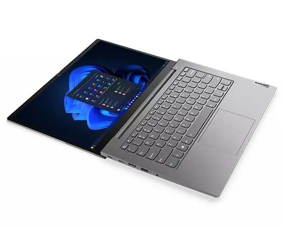 Overhead shot of Lenovo ThinkBook 14 Gen 5 laptop open 180 degrees with Windows 11 Pro Start menu on screen.