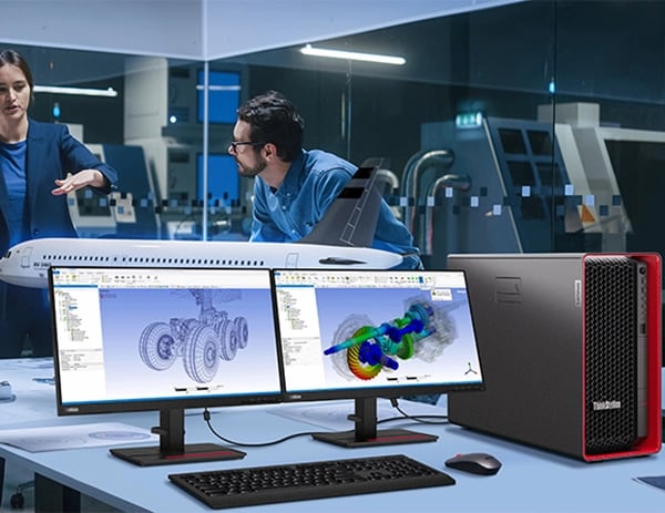 Two monitors showing aeroplane wheel designs, alongside Lenovo ThinkStation P7 workstation, with two engineers in the background