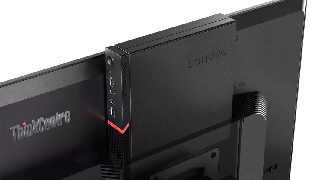 Nærbilde av Lenovo ThinkCentre M715q Tiny plassert bak en skjerm for å fremheve hvor liten den er