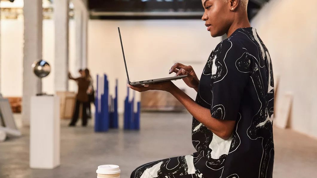 Woman with the 14-inch Yoga Slim 7 laptop