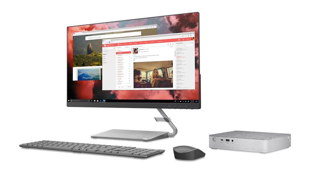 Right-angled view of the IdeaCentre Mini 5i desktop to the right of a monitor, wireless keyboard and wireless mouse