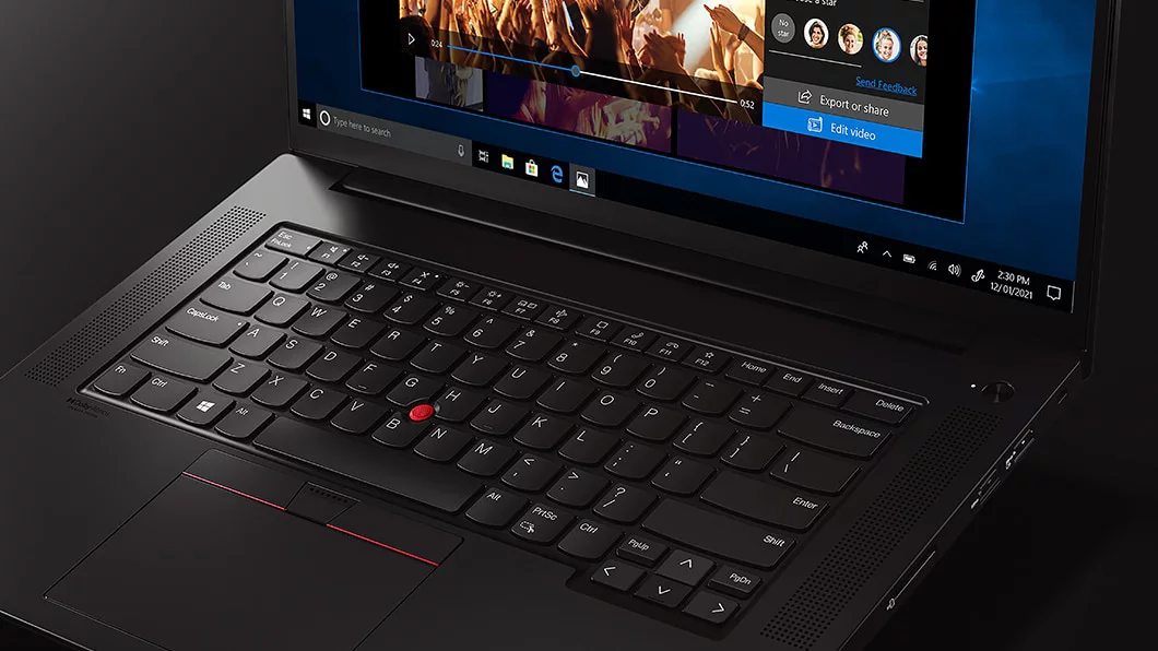 Close-up of keyboard and up-firing speakers on the Lenovo X1 Extreme Gen 4 laptop, with a clipped display showing video controls.